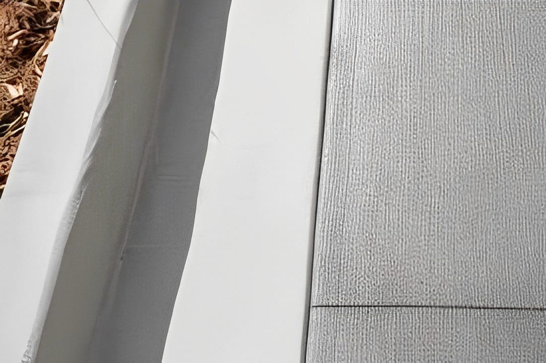 Close-up of textured and smooth surfaces meeting at a corner.